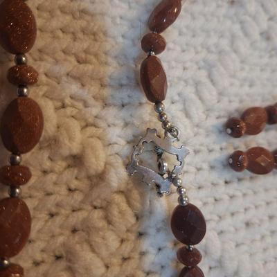 Sale Photo Thumbnail #104: Brown beaded necklace with pendant and matching earrings