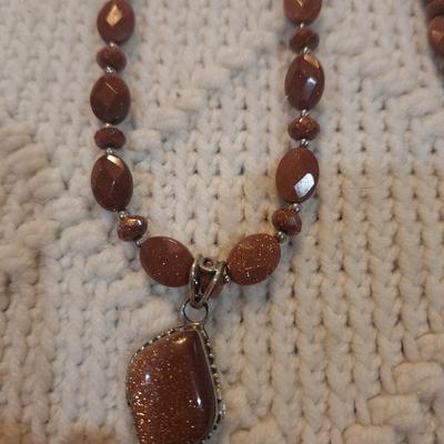 Sale Photo Thumbnail #102: Brown beaded necklace with pendant and matching earrings