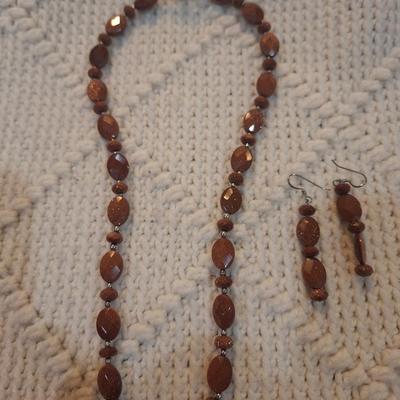Sale Photo Thumbnail #103: Brown beaded necklace with pendant and matching earrings