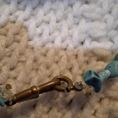 Sale Photo Thumbnail #145: turquoise colored rock chips.- clasp is brass and is not completely closed.  Not the kind of clasp used on a real turquoise necklace but a very pretty costume piece