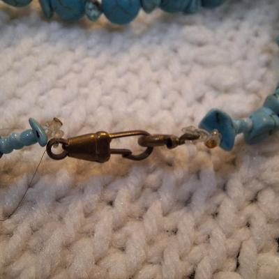 Sale Photo Thumbnail #144: turquoise colored rock chips.- clasp is brass and is not completely closed.  Not the kind of clasp used on a real turquoise necklace but a very pretty costume piece