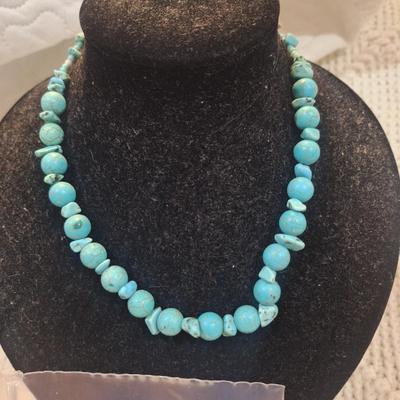Sale Photo Thumbnail #142: turquoise colored rock chips.- clasp is brass and is not completely closed.  Not the kind of clasp used on a real turquoise necklace but a very pretty costume piece