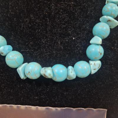 Sale Photo Thumbnail #143: turquoise colored rock chips.- clasp is brass and is not completely closed.  Not the kind of clasp used on a real turquoise necklace but a very pretty costume piece