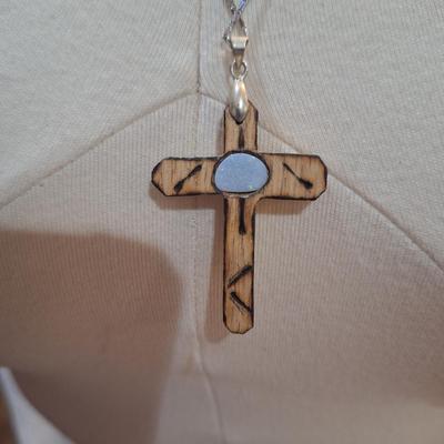 Sale Photo Thumbnail #177: Lot of 2 necklaces, silver chain with wooden cross pendant and leather strap with rock or similar pendant.