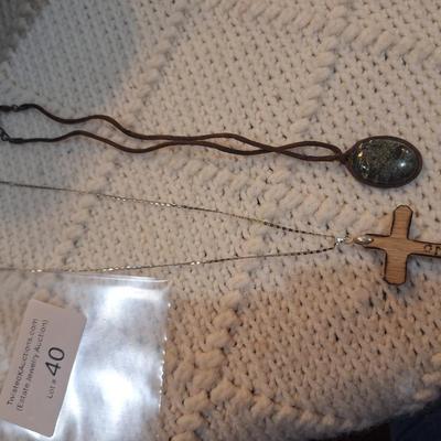 Sale Photo Thumbnail #179: Lot of 2 necklaces, silver chain with wooden cross pendant and leather strap with rock or similar pendant.