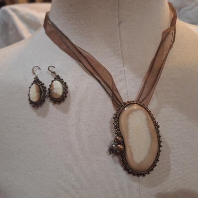Sale Photo Thumbnail #191: handcrafted necklace and earring set with large pendant.  Pendant and earrings have leather backing.  Pendant can also be a brooch.