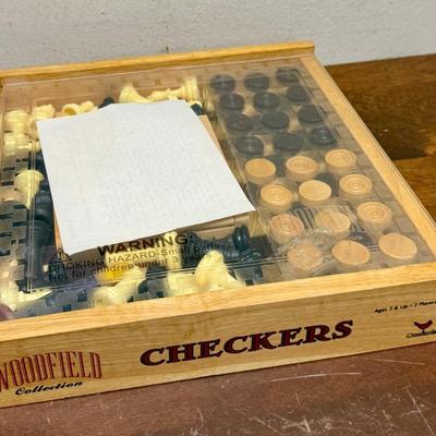 Sale Photo Thumbnail #322: Sliding clear plastic cover.  Includes pieces for checkers and chess (missing the black queen).  Also included is a small hinged lid Tic-Tac-Toe box with 10 pieces.