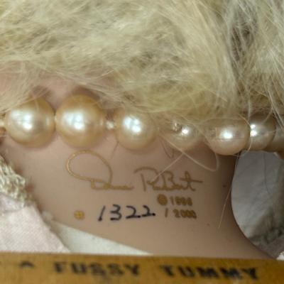 Sale Photo Thumbnail #242: In fair condition. Her hair is a little messy. Her hands have had velcro applied to hands to keep them together in prayer. She's wearing a vintage pearl necklace.