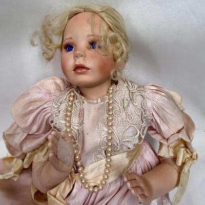 Sale Photo Thumbnail #246: In fair condition. Her hair is a little messy. Her hands have had velcro applied to hands to keep them together in prayer. She's wearing a vintage pearl necklace.
