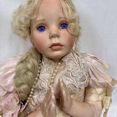 Sale Photo Thumbnail #241: In fair condition. Her hair is a little messy. Her hands have had velcro applied to hands to keep them together in prayer. She's wearing a vintage pearl necklace.
