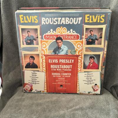 Sale Photo Thumbnail #3: "Roustabout," the soundtrack to the 1964 American musical film of the same name starring Elvis Presley. 
Here are some details about the album and film:
Release Information: "Roustabout" is the ninth soundtrack album by Elvis Presley, released in October 