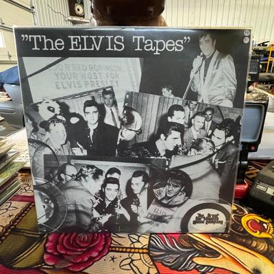 Sale Photo Thumbnail #24: "The ELVIS Tapes", a vinyl LP featuring interview recordings of Elvis Presley. 
Here's more about this album:
Content: The LP primarily features a recording of a press conference given by Elvis Presley prior to his performance at the Empire Stadium in Van