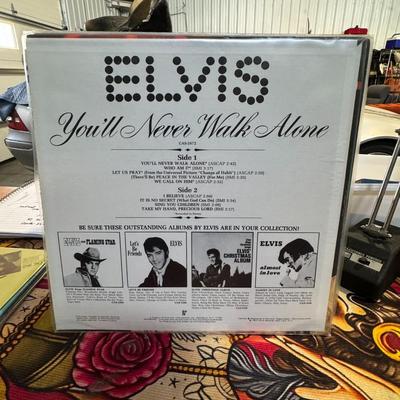 Sale Photo Thumbnail #103: You'll Never Walk Alone album by Elvis Presley. Released in 1971 by RCA Records, this compilation album features gospel recordings from 1957 onward, along with two previously unreleased tracks. The album includes the title track, "You'll Never Walk Alone,