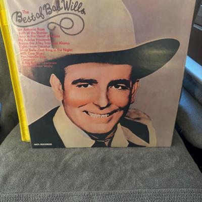Sale Photo Thumbnail #185: "The Best of Bob Wills" by Bob Wills & His Texas Playboys. 
This compilation album showcases some of the iconic Western Swing artist's greatest hits, released by MCA Records. Different pressings of this album exist, with some sources indicating a release 