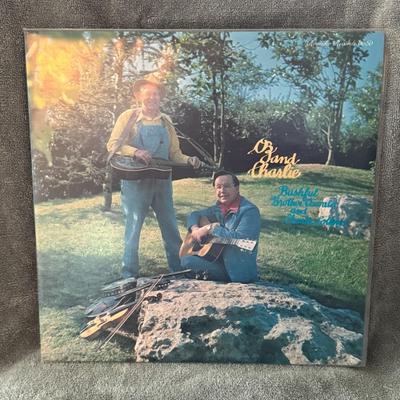 Sale Photo Thumbnail #223: "Oz And Charlie" by Bashful Brother Oswald and Charlie Collins. 
Here are some details about this album:
Artists: Bashful Brother Oswald and Charlie Collins.
Title: Oz And Charlie.
Release Year: 1976.
Label: Rounder Records.
Genre & Style: Primarily Folk,