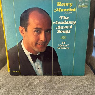 Sale Photo Thumbnail #355: "Henry Mancini Presents The Academy Award Songs", a classic vinyl release by the acclaimed composer and conductor Henry Mancini. 
Here's more about this album:
Artist: Henry Mancini and His Orchestra and Chorus.
Title: "Henry Mancini Presents The Academy 