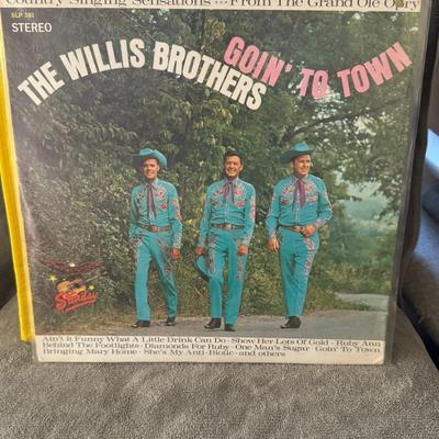 Sale Photo Thumbnail #365: "Goin' To Town" by The Willis Brothers. 
Additional information about the album and band includes:
Artist: The Willis Brothers were a country music group, known for their association with the Grand Ole Opry, as indicated on the album cover.
Album Title: T