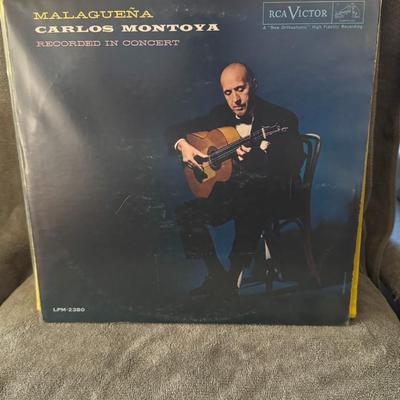 Sale Photo Thumbnail #419: "Malagueña" by Carlos Montoya, released on the RCA Victor label. 
Here's more information about the album:
Artist: Carlos Montoya (a renowned flamenco guitarist).
Title: Malagueña.
Release Information: "Recorded in Concert" and released by RCA Victor.
C