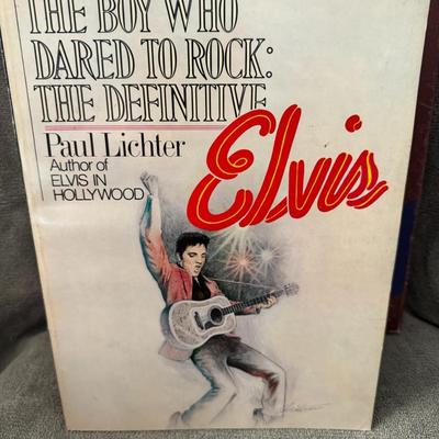 Sale Photo Thumbnail #437: "The Boy Who Dared to Rock: The Definitive Elvis" by Paul Lichter. 
This book is a biography of Elvis Presley and is known for its extensive coverage of his recording sessions, record covers from around the world (including rare and bootleg albums), and l