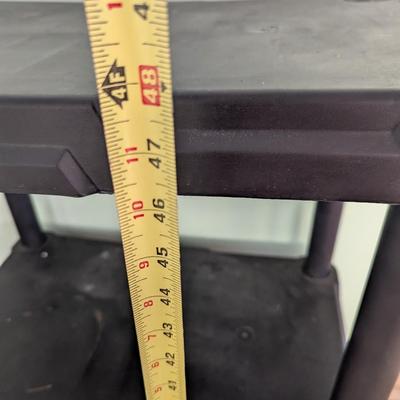 Two four-tier plastic shelves