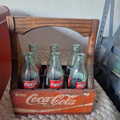 Wooden coca cola tray with glass bottles