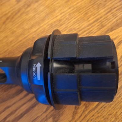 Phone holder that sits in car drink holder, base is adjustable to fit various size cup holders