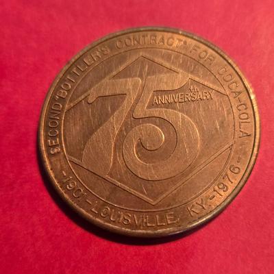Sale Photo Thumbnail #13: This auction lot is for a Brass Coca-Cola 75th Anniversary in Louisville Commemorative Coin.  It is in used condition but still a very nice addition to your Coca-Cola or local business token collection.