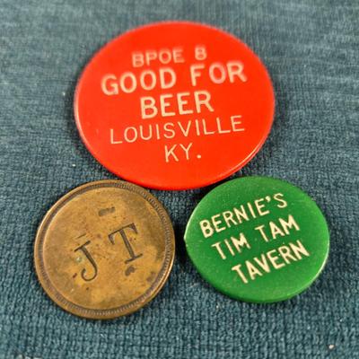 Sale Photo Thumbnail #52: This auction lot is for a Vintage Trio of Louisville Beer Tokens. There are two plastic beer tokens:  BPOE 8 and Bernie's Tim Tam Tavern.  The brass one is for JT's.  All are good for 1 beer.   A bit of Louisville memorabilia for you.  If anyone knows whe