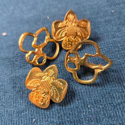 Sale Photo Thumbnail #64: This auction lot is for Girl Scout Lapel Pins. This is a nice group of brass Girl Scout Pins:  The 2 solid pins are actual Girl Scout Pins, the 2 outlined pins are for the Brownies.  All pins are in good condition