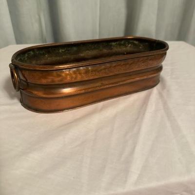 Sale Photo Thumbnail #101: The sweet little copper container has two handles on the side and is 10 inches long and 4 inches wide.