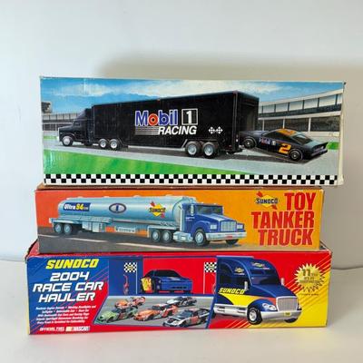 LOT 107: Sunoco Toy Tanker Truck, 2004 Race Car Hauler, Mobile Racing Truck, Humble Toy Tanker Truck & Mobil Collectible Toy Truck