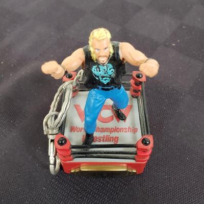 LOT 147: Vintage WWF Road Champs Cars, Roddy Piper Monster Truck, WCW Diamond Dallas Page Keychain & John Cena Action Figure