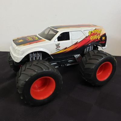 LOT 147: Vintage WWF Road Champs Cars, Roddy Piper Monster Truck, WCW Diamond Dallas Page Keychain & John Cena Action Figure