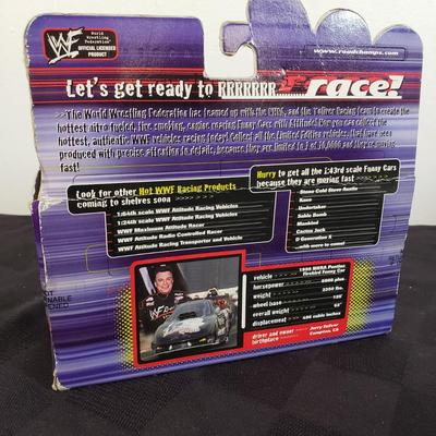 LOT 147: Vintage WWF Road Champs Cars, Roddy Piper Monster Truck, WCW Diamond Dallas Page Keychain & John Cena Action Figure