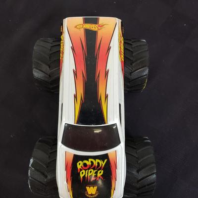 LOT 147: Vintage WWF Road Champs Cars, Roddy Piper Monster Truck, WCW Diamond Dallas Page Keychain & John Cena Action Figure