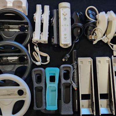 Sale Photo Thumbnail #61: Nintendo Wii Huge Lot of Racing Wheels Controllers Stands & much more.
Will receive all items pictured as is. A couple controllers do not have backs.