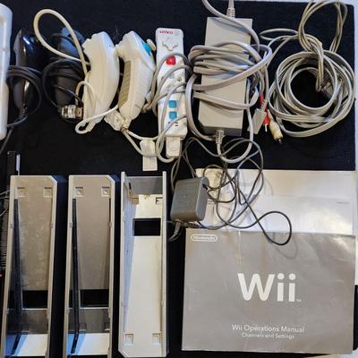 Sale Photo Thumbnail #64: Nintendo Wii Huge Lot of Racing Wheels Controllers Stands & much more.
Will receive all items pictured as is. A couple controllers do not have backs.