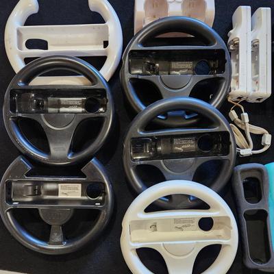 Sale Photo Thumbnail #62: Nintendo Wii Huge Lot of Racing Wheels Controllers Stands & much more.
Will receive all items pictured as is. A couple controllers do not have backs.