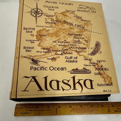 Sale Photo Thumbnail #171: Synthetic Tan Leather cover with a map of Alaska with many points of interest identified.  Approx. size 8.5' X 10". Holds 208 4' x 6" prints. Great for holding Alaska cruise or other Alaska vacation photos.  Like new condition.