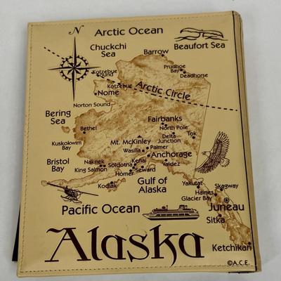 Sale Photo Thumbnail #172: Synthetic Tan Leather cover with a map of Alaska with many points of interest identified.  Approx. size 8.5' X 10". Holds 208 4' x 6" prints. Great for holding Alaska cruise or other Alaska vacation photos.  Like new condition.