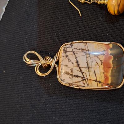 Sale Photo Thumbnail #711: Wired rock pendant and similar colored earrings.