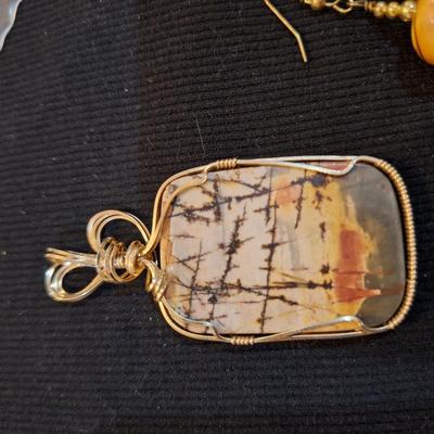 Sale Photo Thumbnail #712: Wired rock pendant and similar colored earrings.