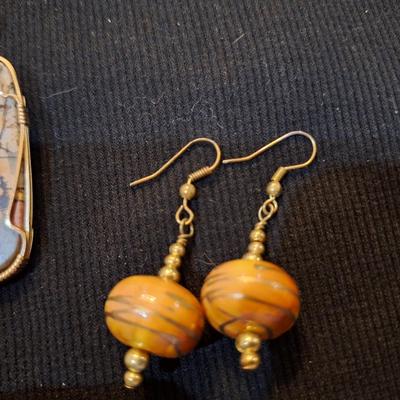 Sale Photo Thumbnail #714: Wired rock pendant and similar colored earrings.