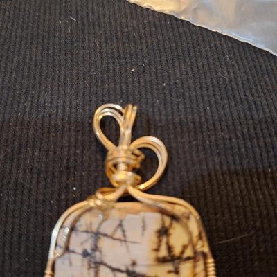 Sale Photo Thumbnail #713: Wired rock pendant and similar colored earrings.