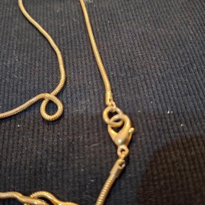 Sale Photo Thumbnail #719: long gold tone necklace with pendant