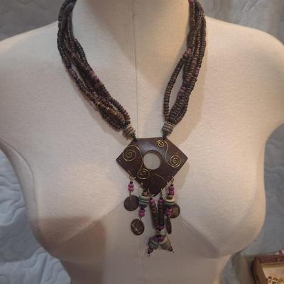 Sale Photo Thumbnail #784: large statement necklace with geometric pendant and dangles.