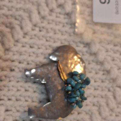 Sale Photo Thumbnail #834: Buffalo shaped brooch with small turquoise cluster, signed by artist