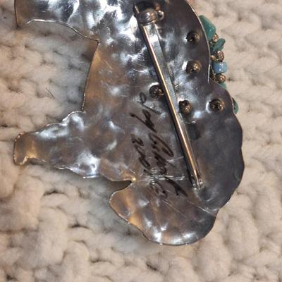 Sale Photo Thumbnail #832: Buffalo shaped brooch with small turquoise cluster, signed by artist