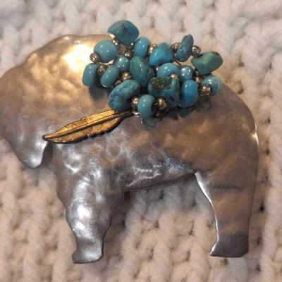 Sale Photo Thumbnail #831: Buffalo shaped brooch with small turquoise cluster, signed by artist
