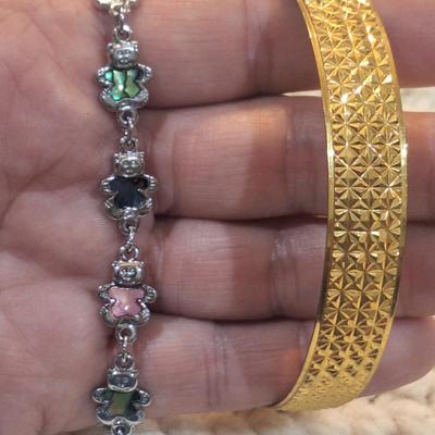 Sale Photo Thumbnail #891: 2 bracelets, silver tone bears and gold tone cuff
